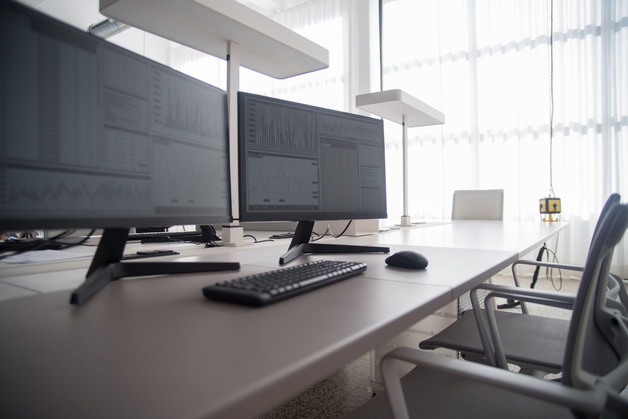 Modern office workspace with two monitors and keyboard on a clean desk