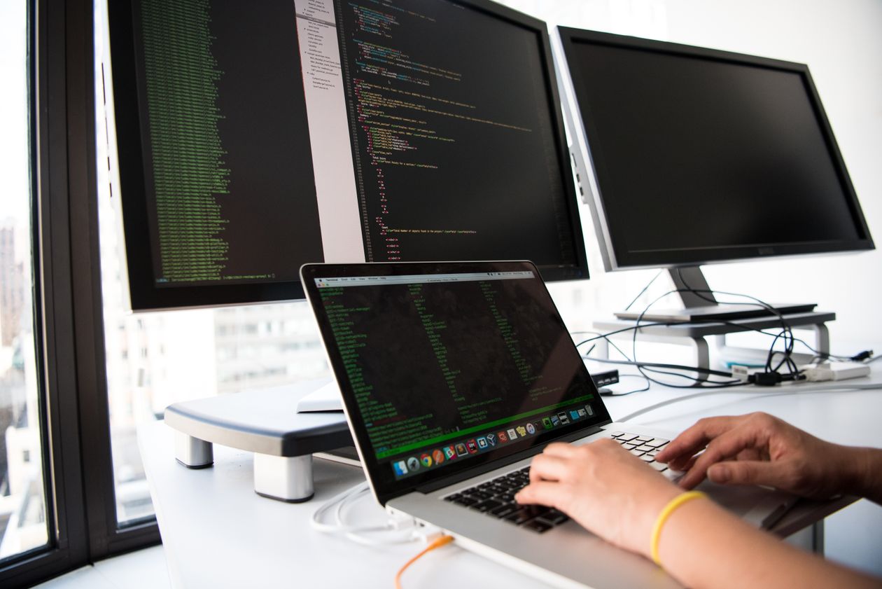 IT professionals working on laptops in a modern business technology environment