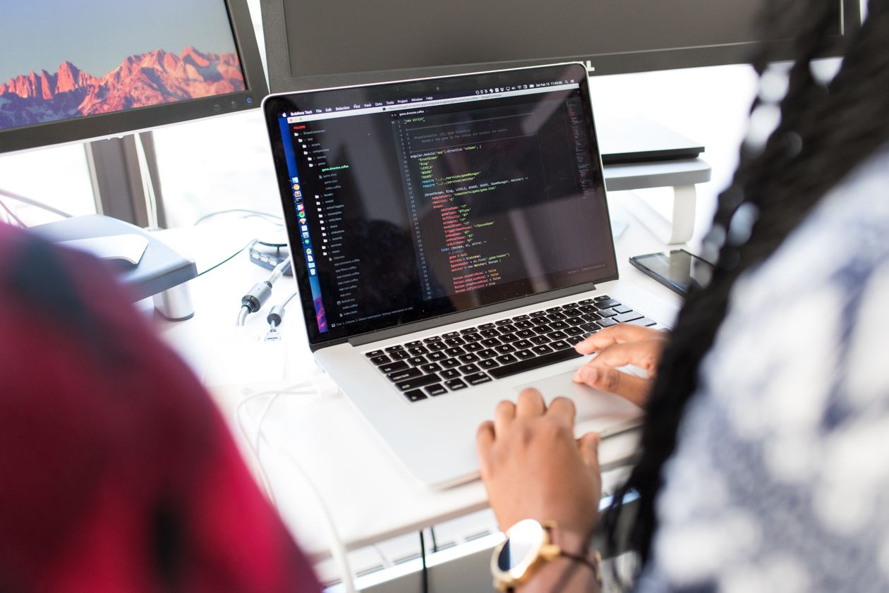Team of professionals working on computers in a modern office environment